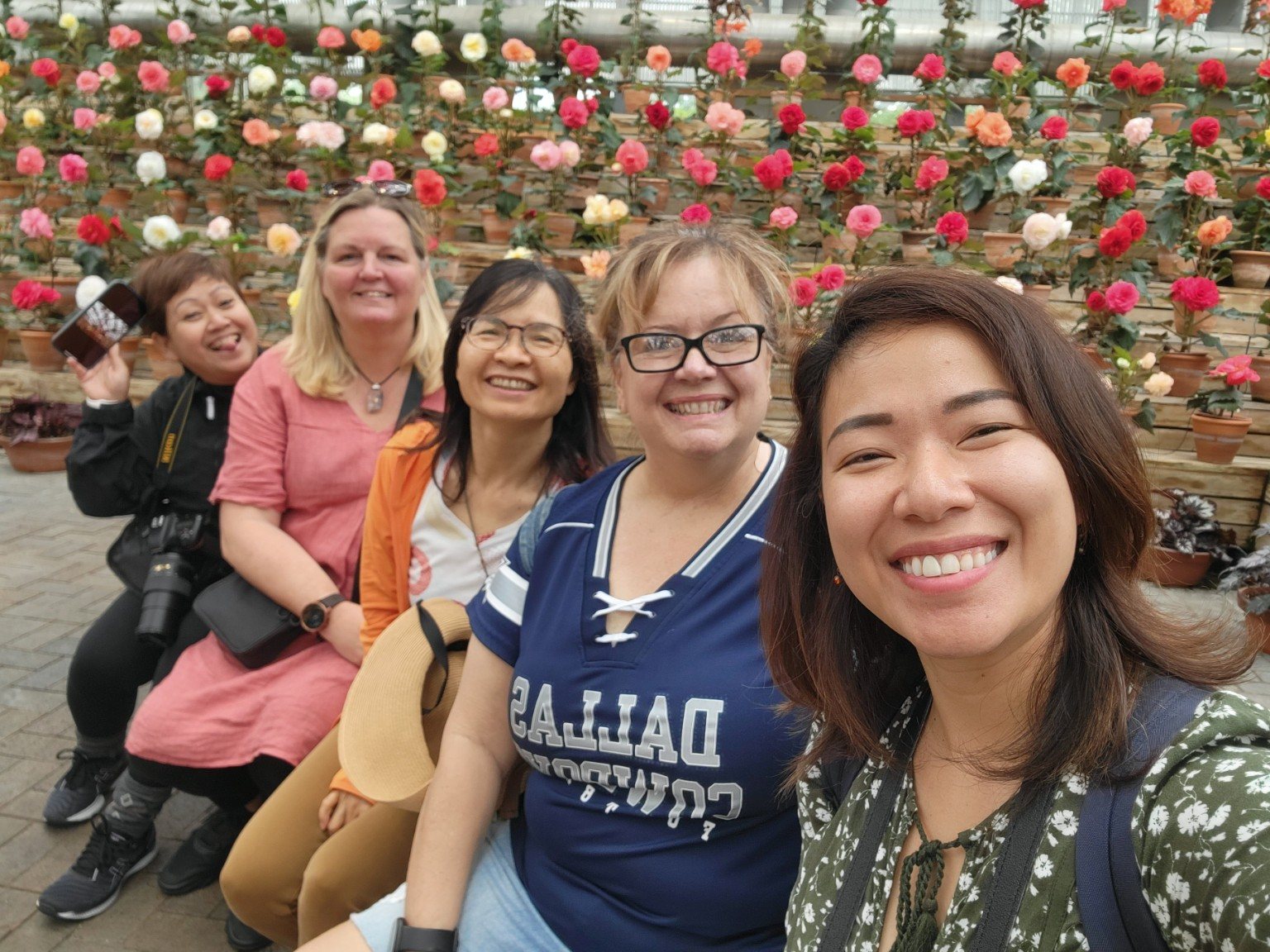 Friends together surrounded by flowers